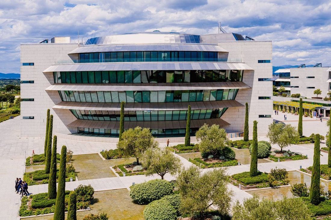 Banco Santander: Main building with stacked glass bands, in front of a garden of olive trees and cypresses