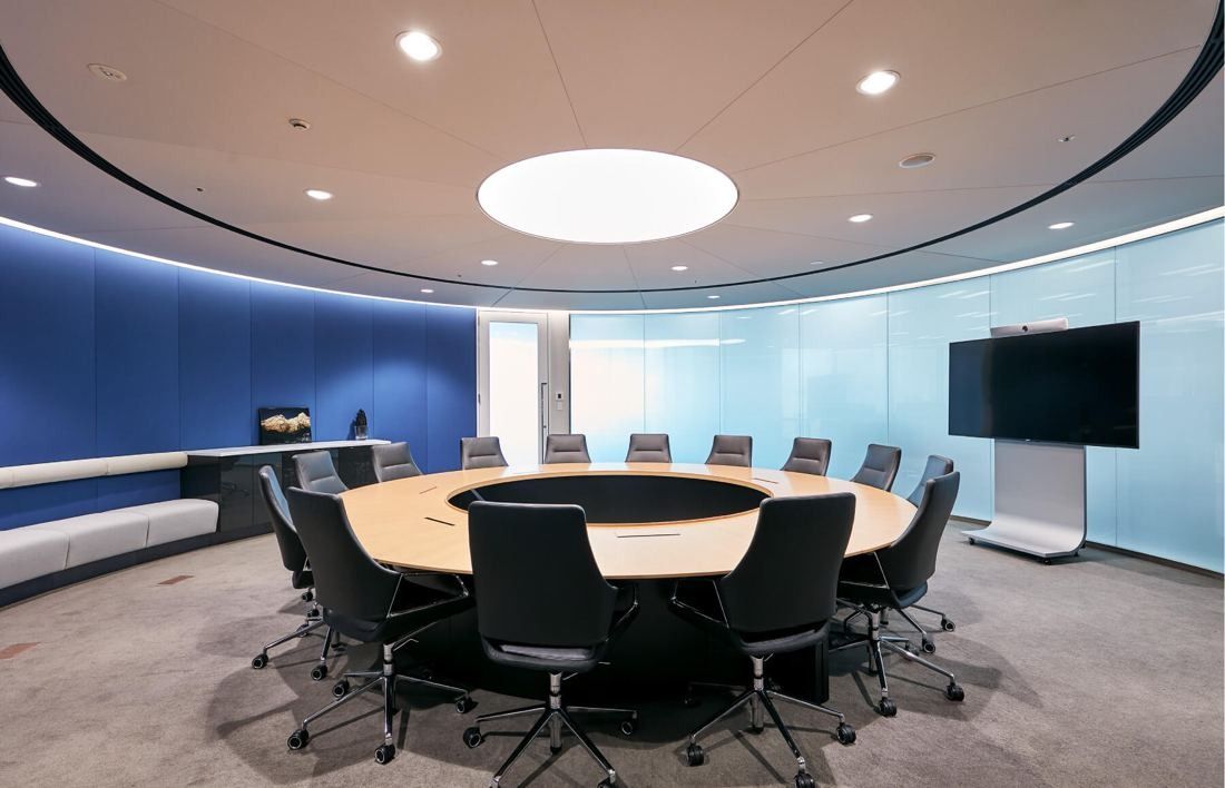 SEGA: Round meeting room with a large circular table and blue curved wall