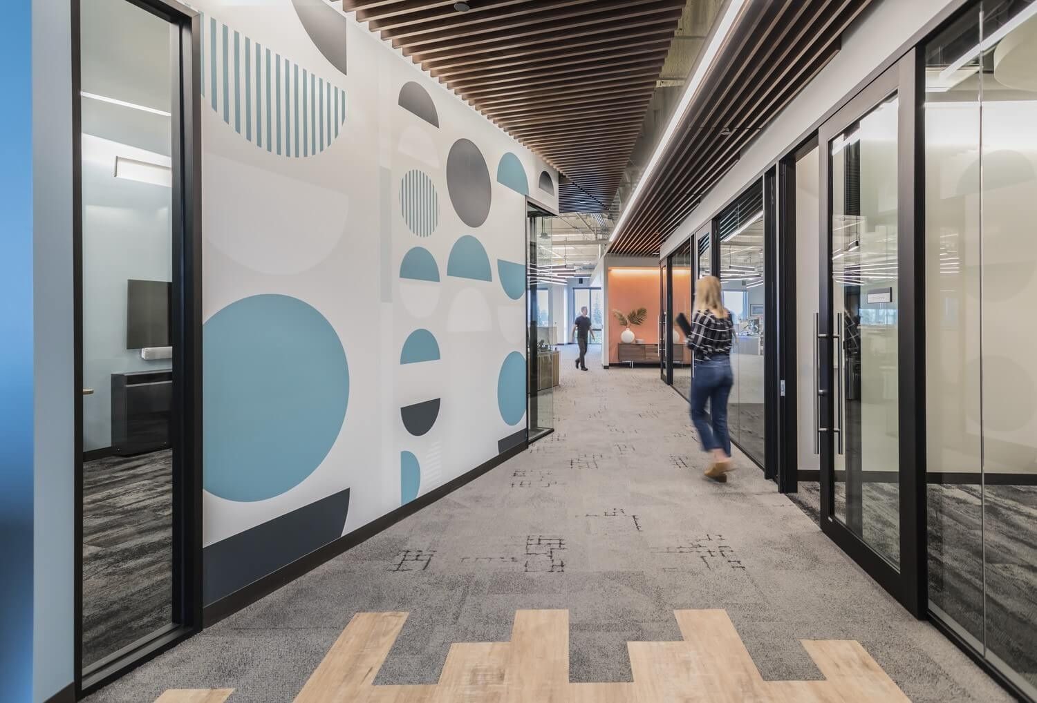 ServiceNow: A corridor with a circle-pattern mural
