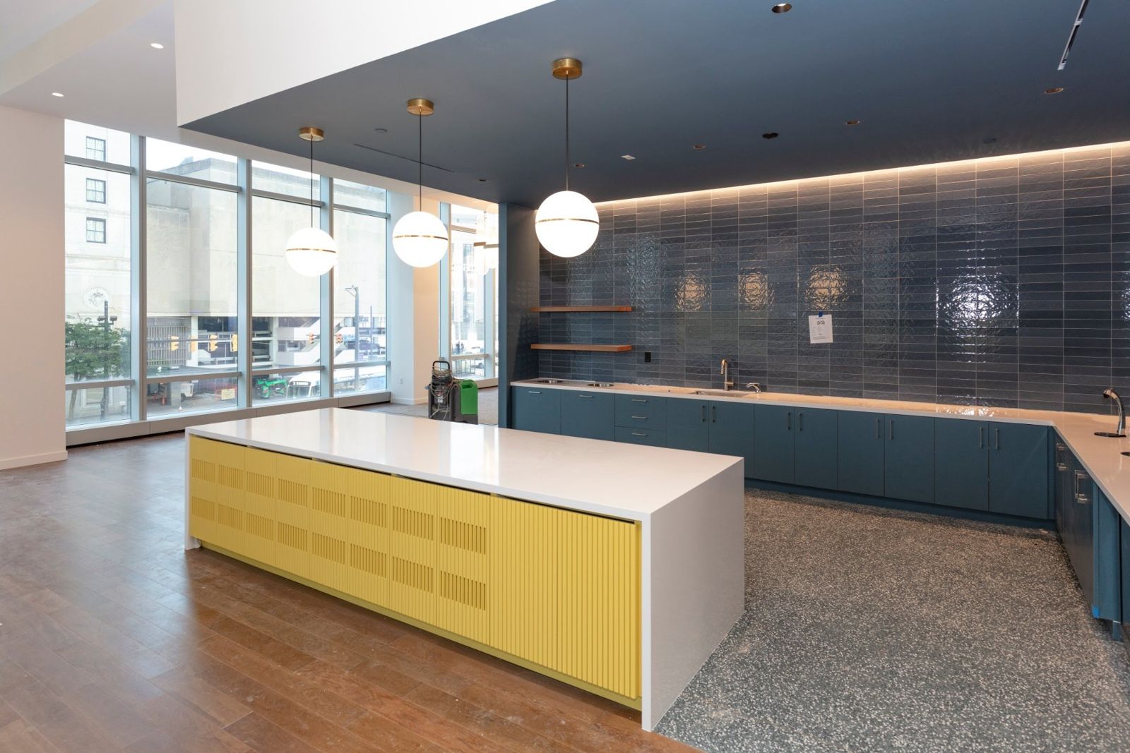 Sherwin-Williams: Kitchenette with a yellow island and blue tiles