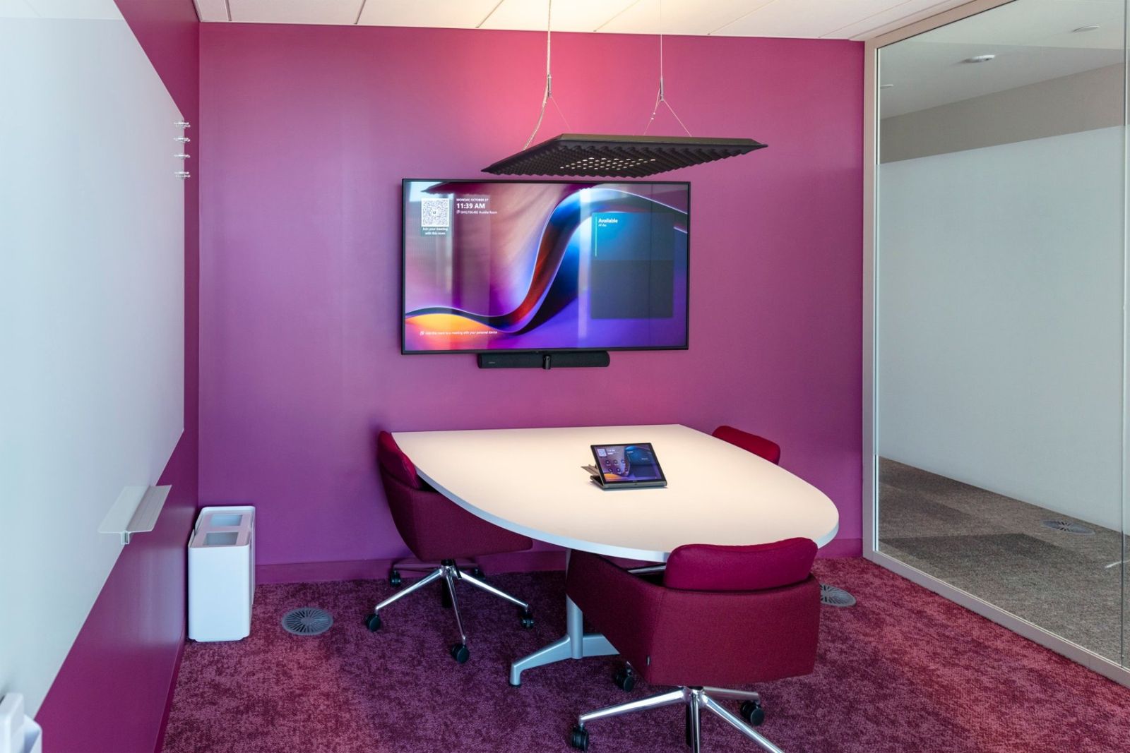 Sherwin-Williams: Meeting room with magenta walls and carpet and a round white table