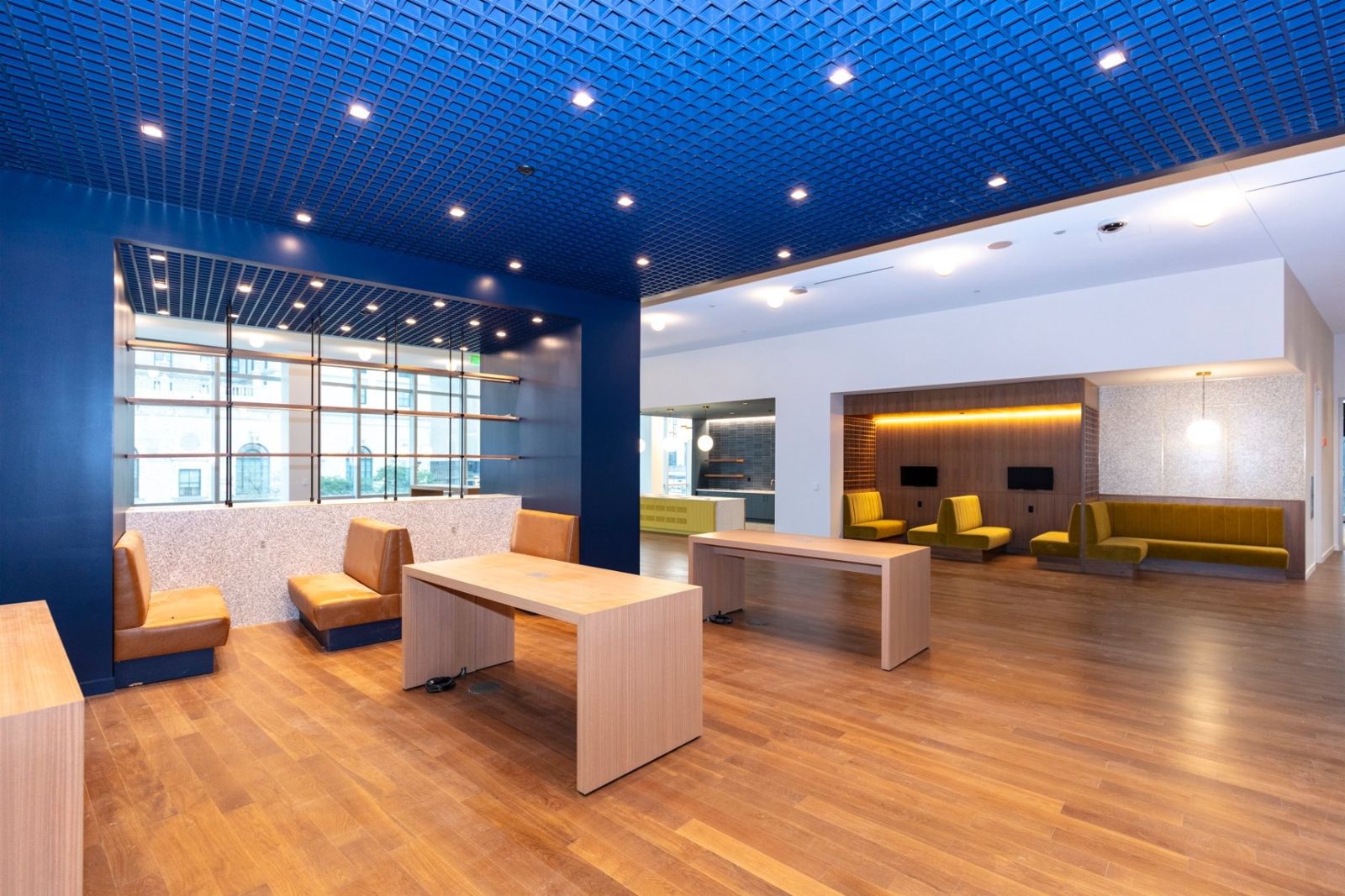 Sherwin-Williams: Workspace under a deep blue ceiling with desks and lounge chairs