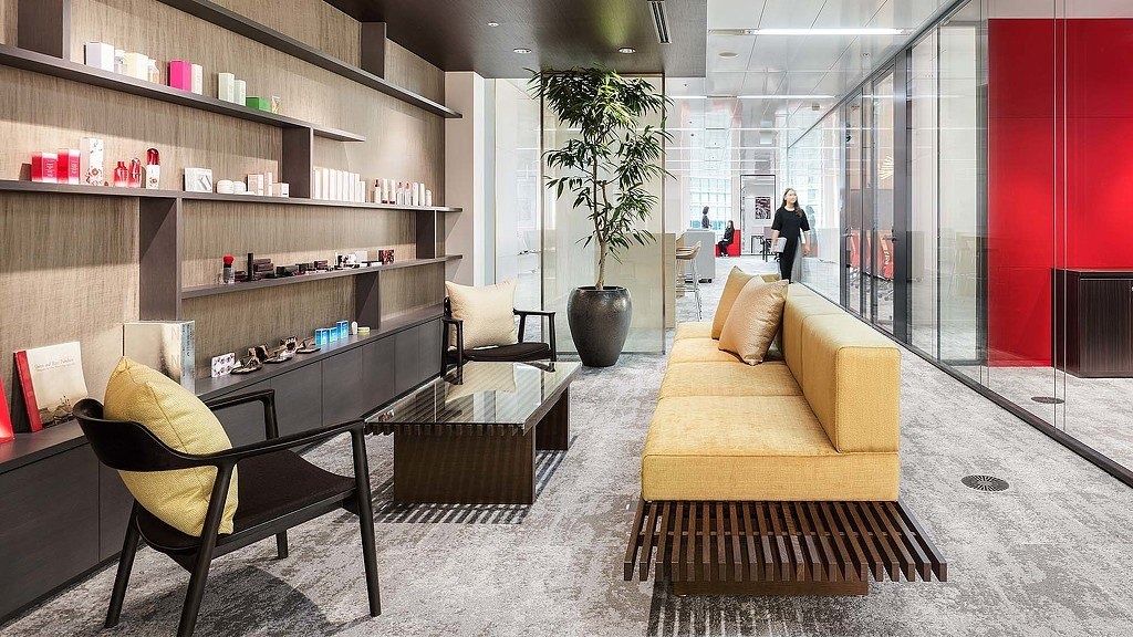 Shiseido: Lounge with sofas, shelves and warm lighting