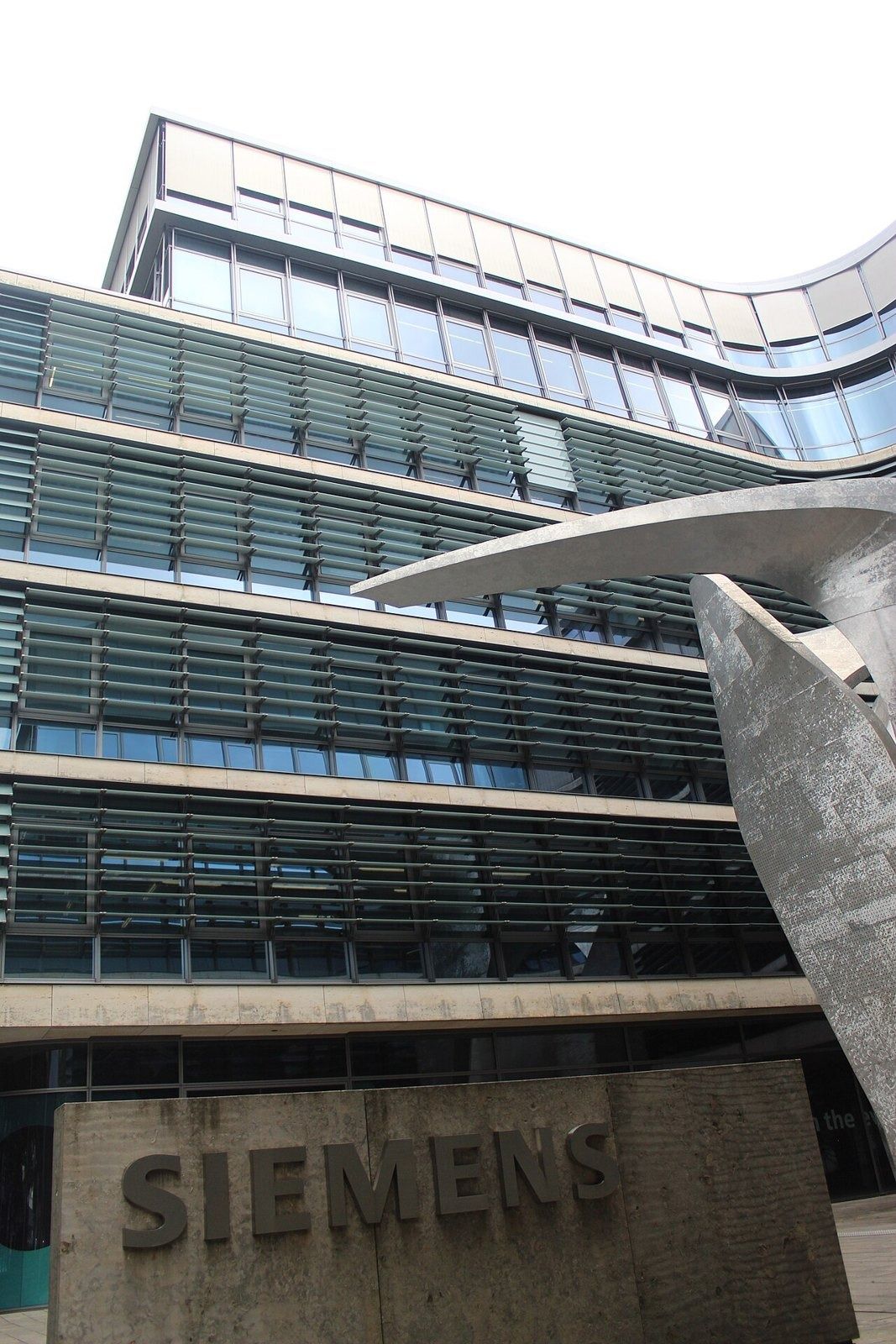 Siemens: Curved glass façade with a Siemens stone sign