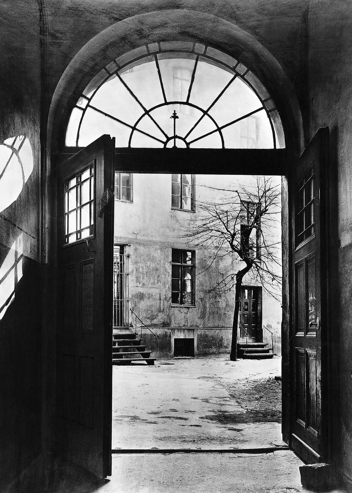 Old drawing of an arched door onto a courtyard