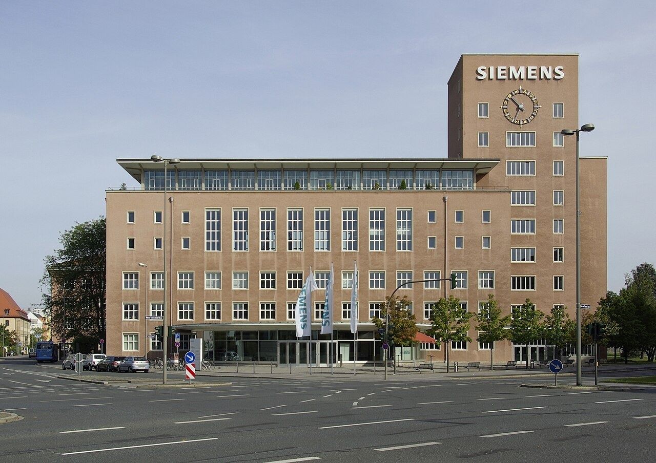 Raspberry-colored office building with a clock tower