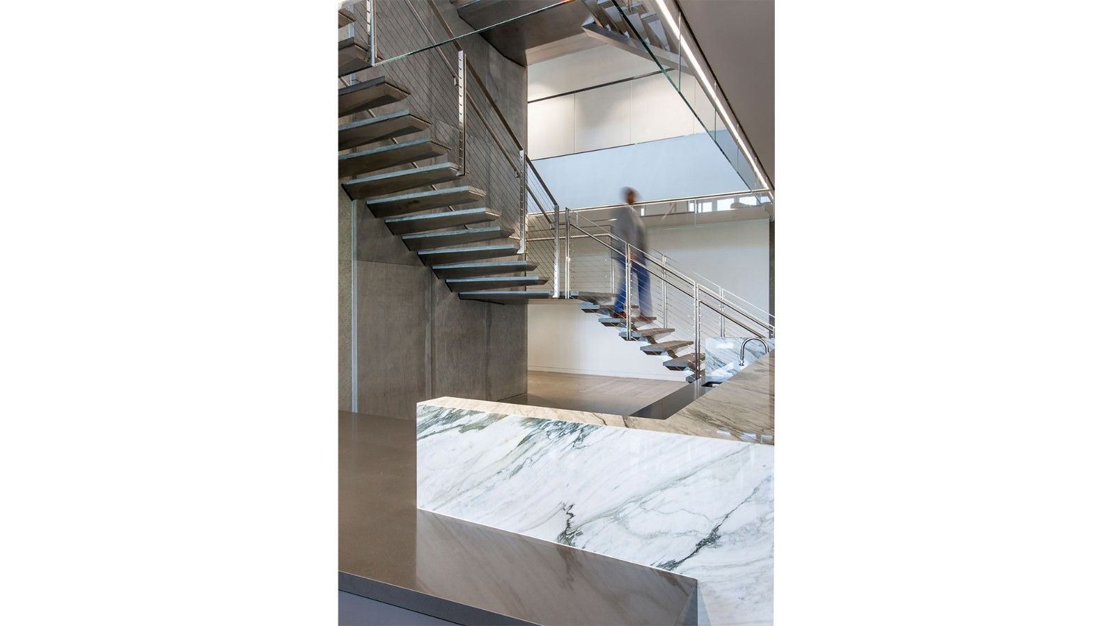 Silicon Labs: A floating steel staircase with a stone wall
