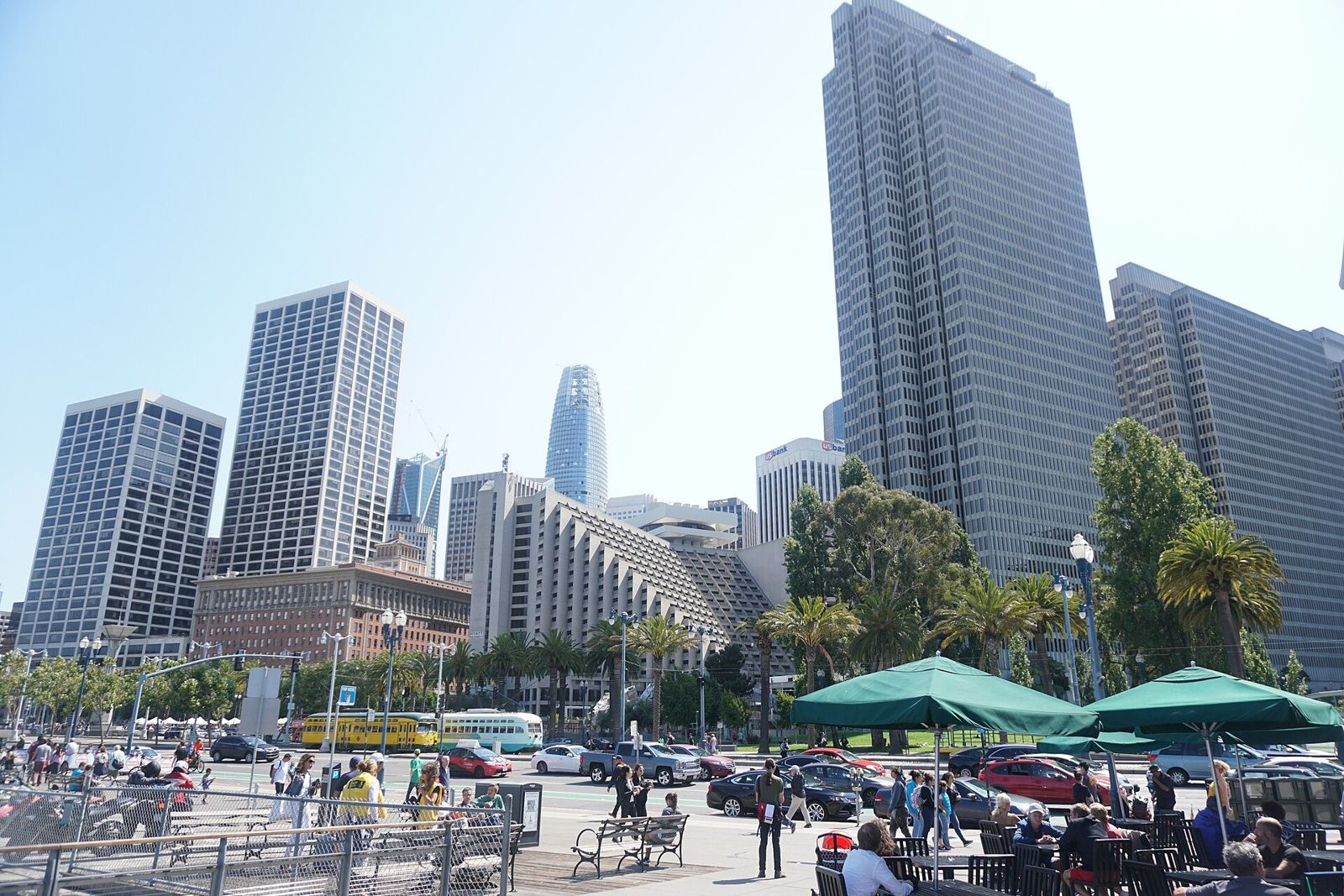 Slack: Plaza with tables and umbrellas below office towers