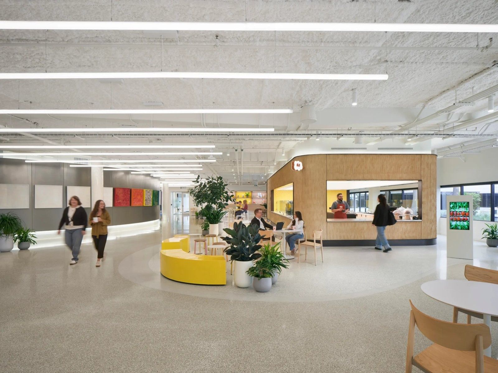 Snap: A bright open floor with planters and a yellow bench