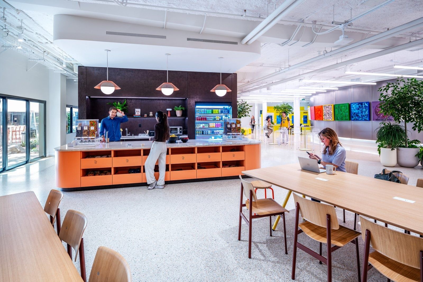 Snap: An orange café counter with long wooden tables