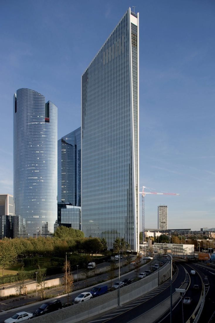 Société Générale: Angular glass tower beside two rounded towers, with a road running below