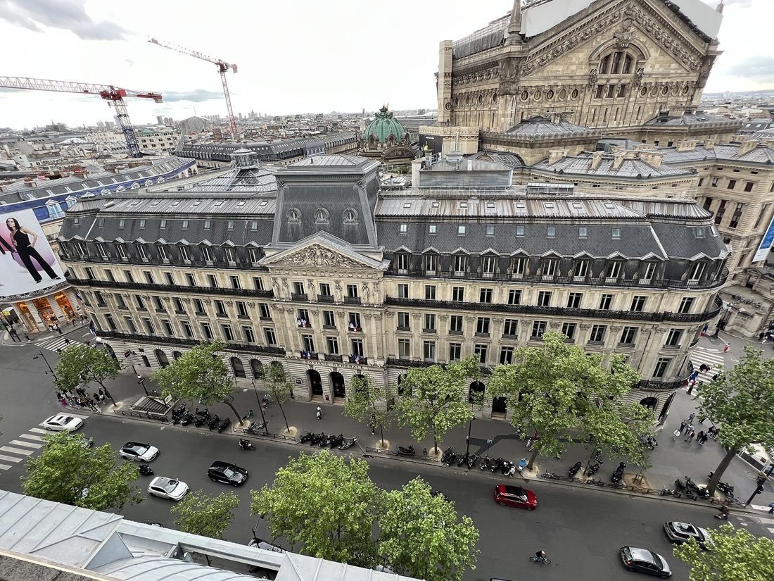 Société Générale: High view of the building's pediment facade and the boulevard, with the Opéra roof behind