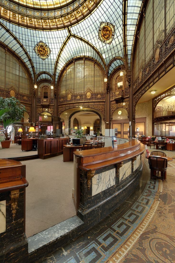 Société Générale: Ornate banking hall with curved wooden and marble counter, mosaic floor and arched glass vaults