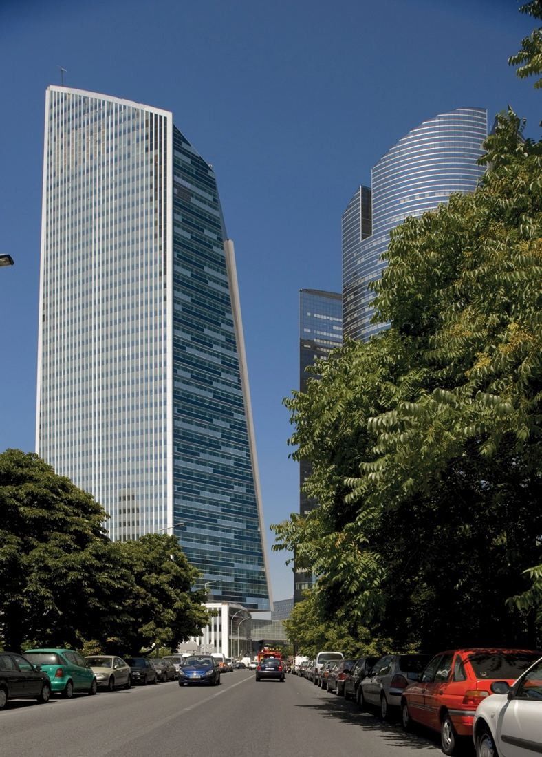 Société Générale: Tall glass tower above a tree-lined street with parked cars