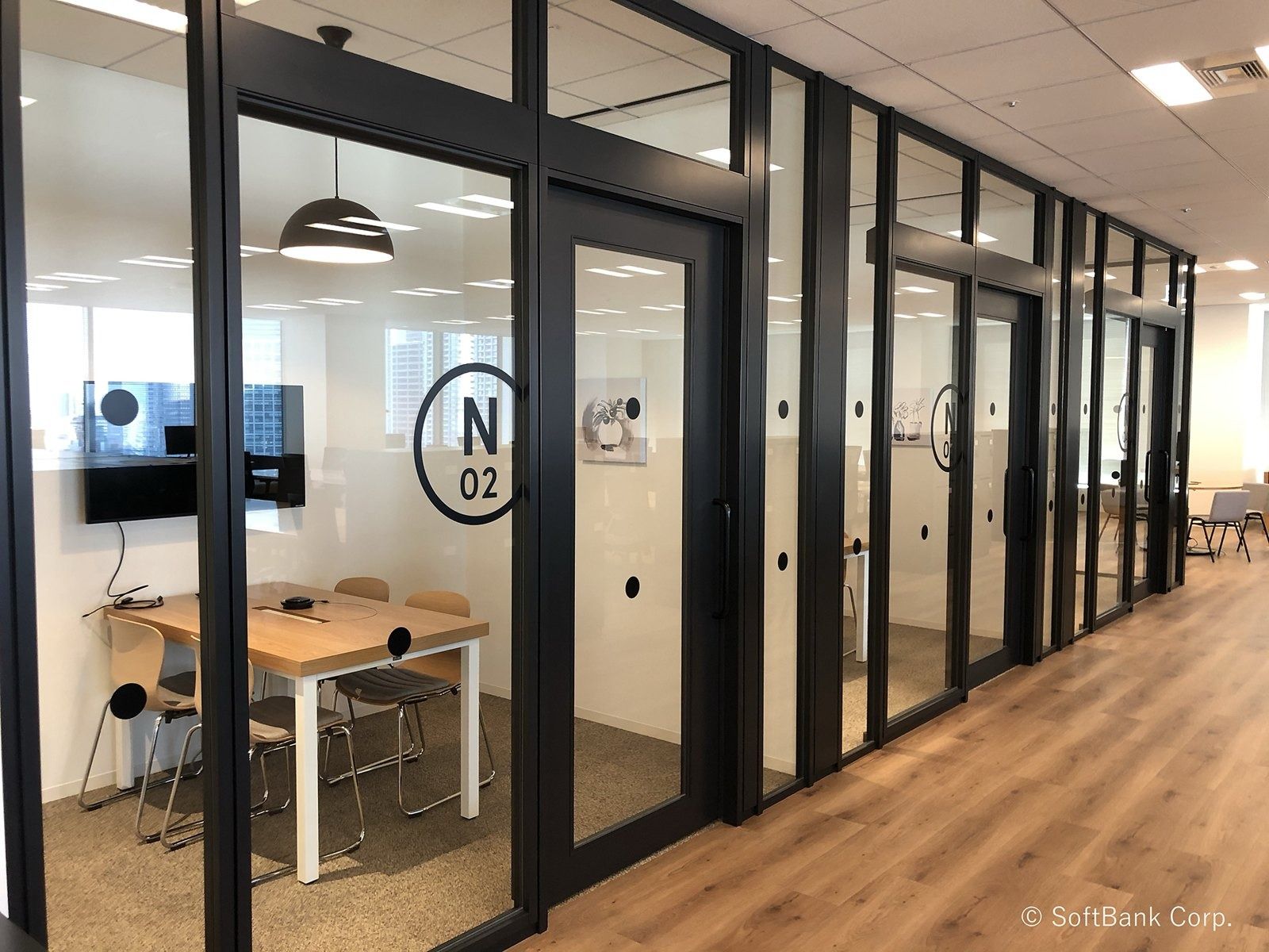 SoftBank Group: Glass-walled meeting rooms along a corridor
