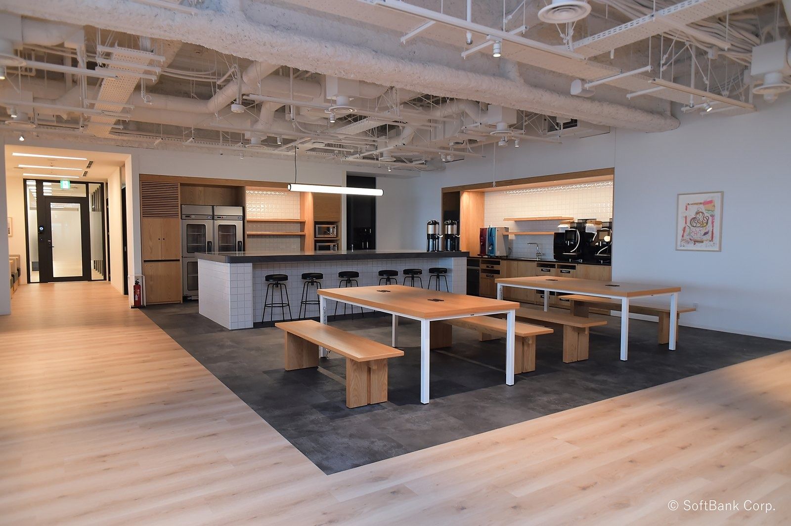 SoftBank Group: Kitchen counter and long tables in an open lounge