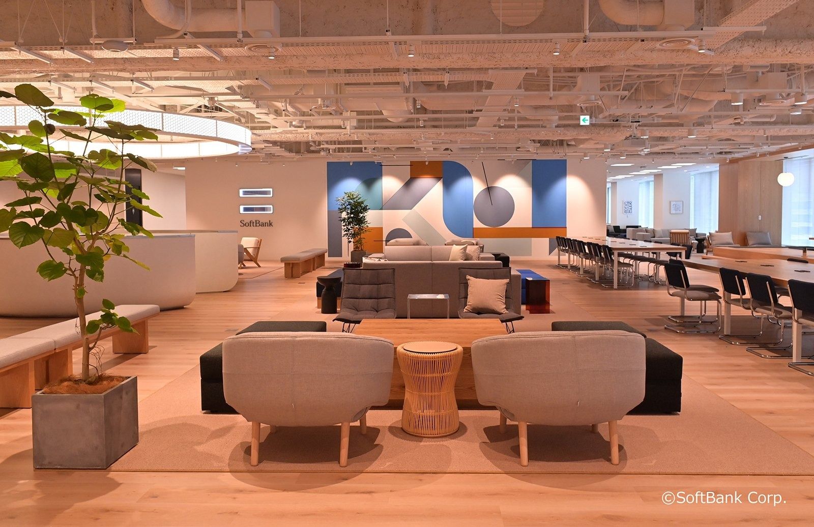 SoftBank Group: Lounge chairs, plants and a long work table