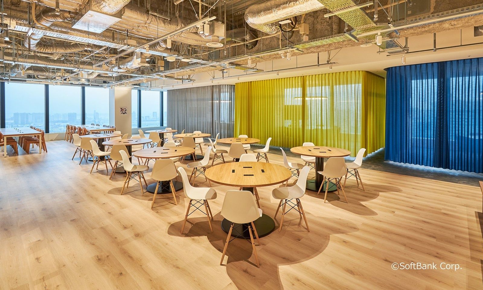 SoftBank Group: Round tables in front of yellow and blue curtains