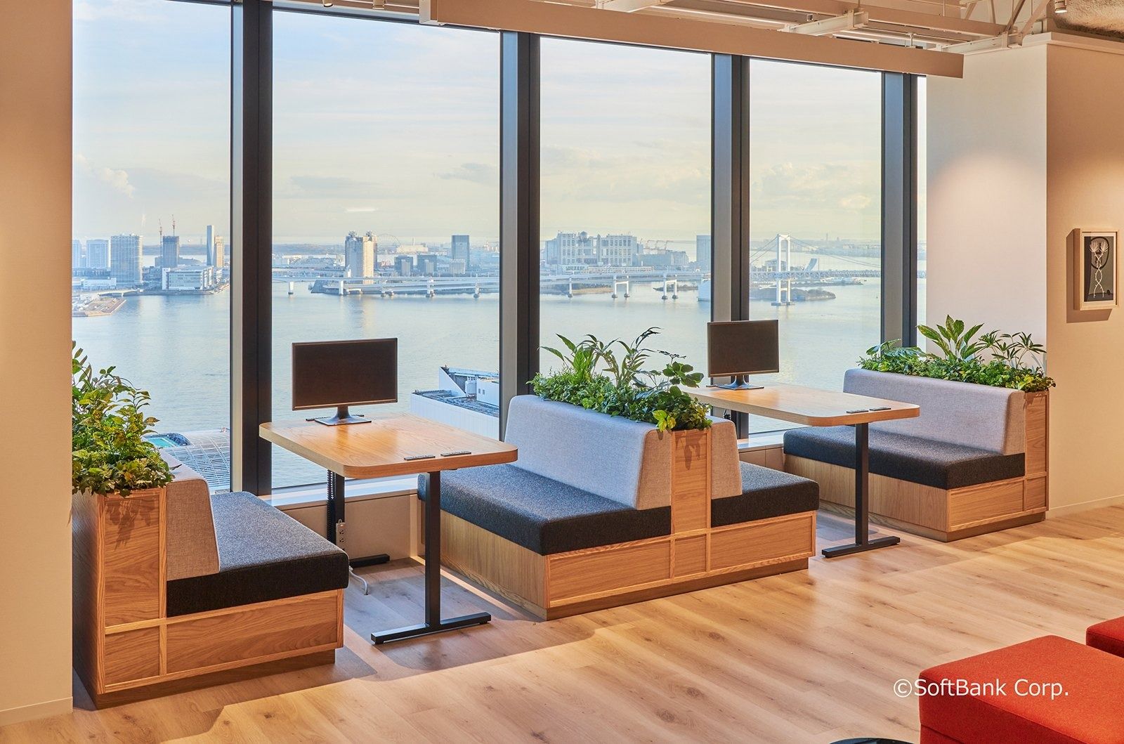 SoftBank Group: Window booths with plants overlooking Tokyo Bay