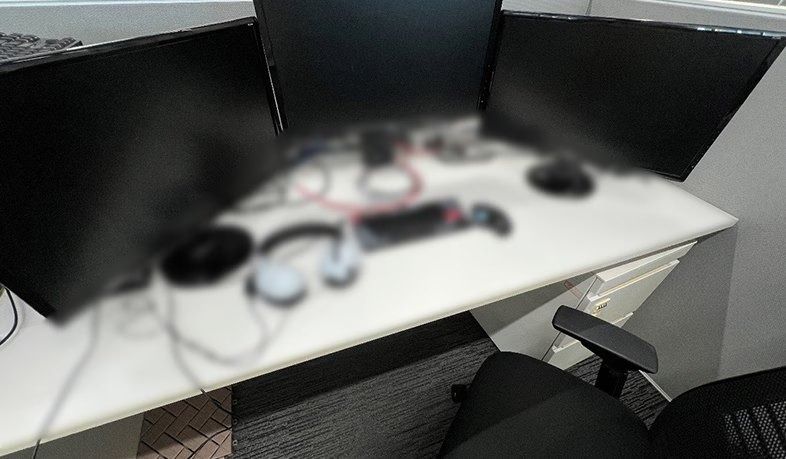 Sony Group: A desk with monitors and headphones