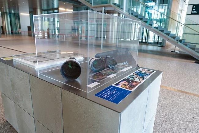 Sony Group: A glass display case with cameras
