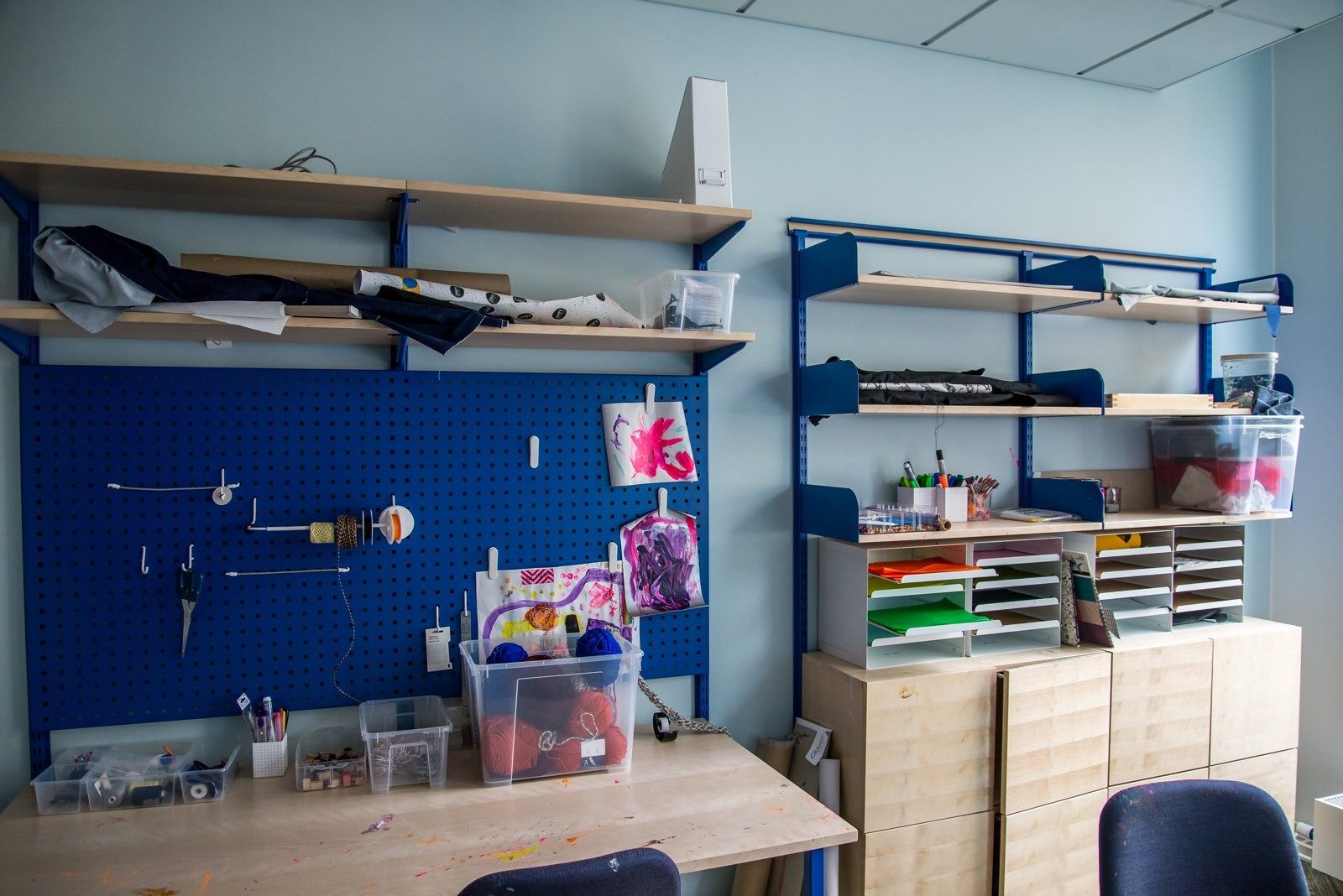 Spotify: A craft room with pegboard and shelves