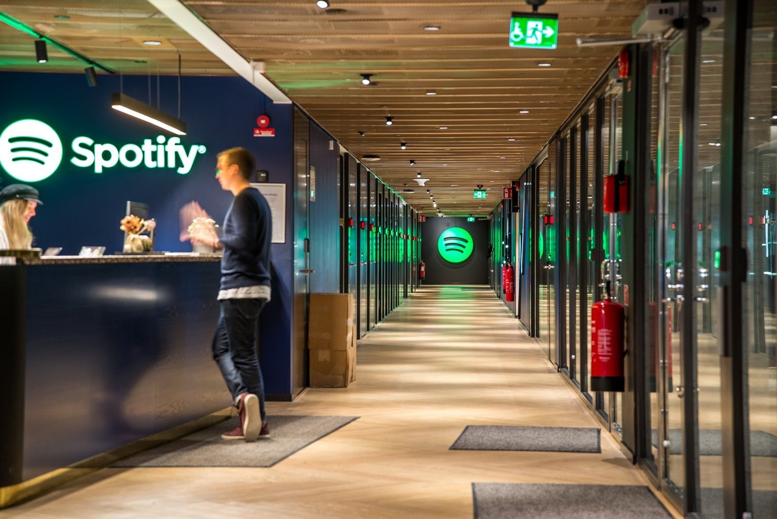 Spotify: A reception desk under a lit Spotify sign