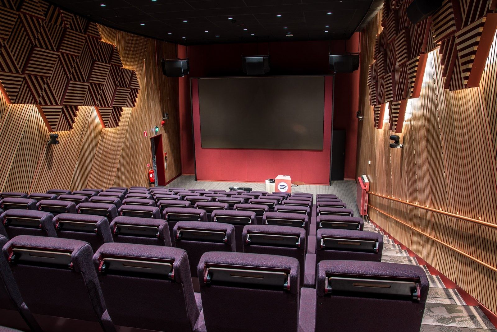 Spotify: A small cinema with purple seats and wooden acoustic walls