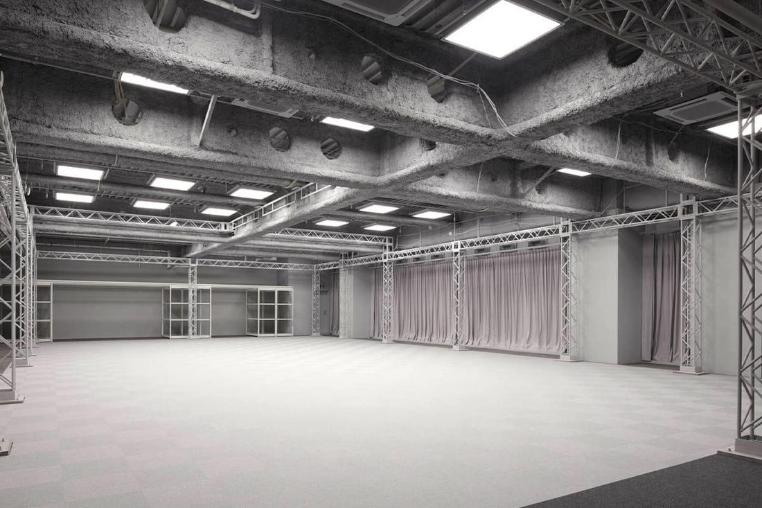 Square Enix: Wide motion-capture stage with trusses, ceiling lights and curtains