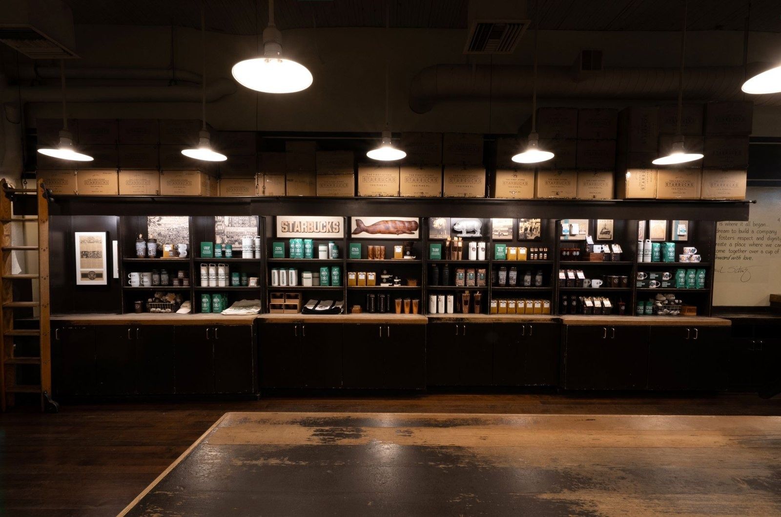 Starbucks: Dark wood shelves and pendant lights inside the reimagined Pike Place store