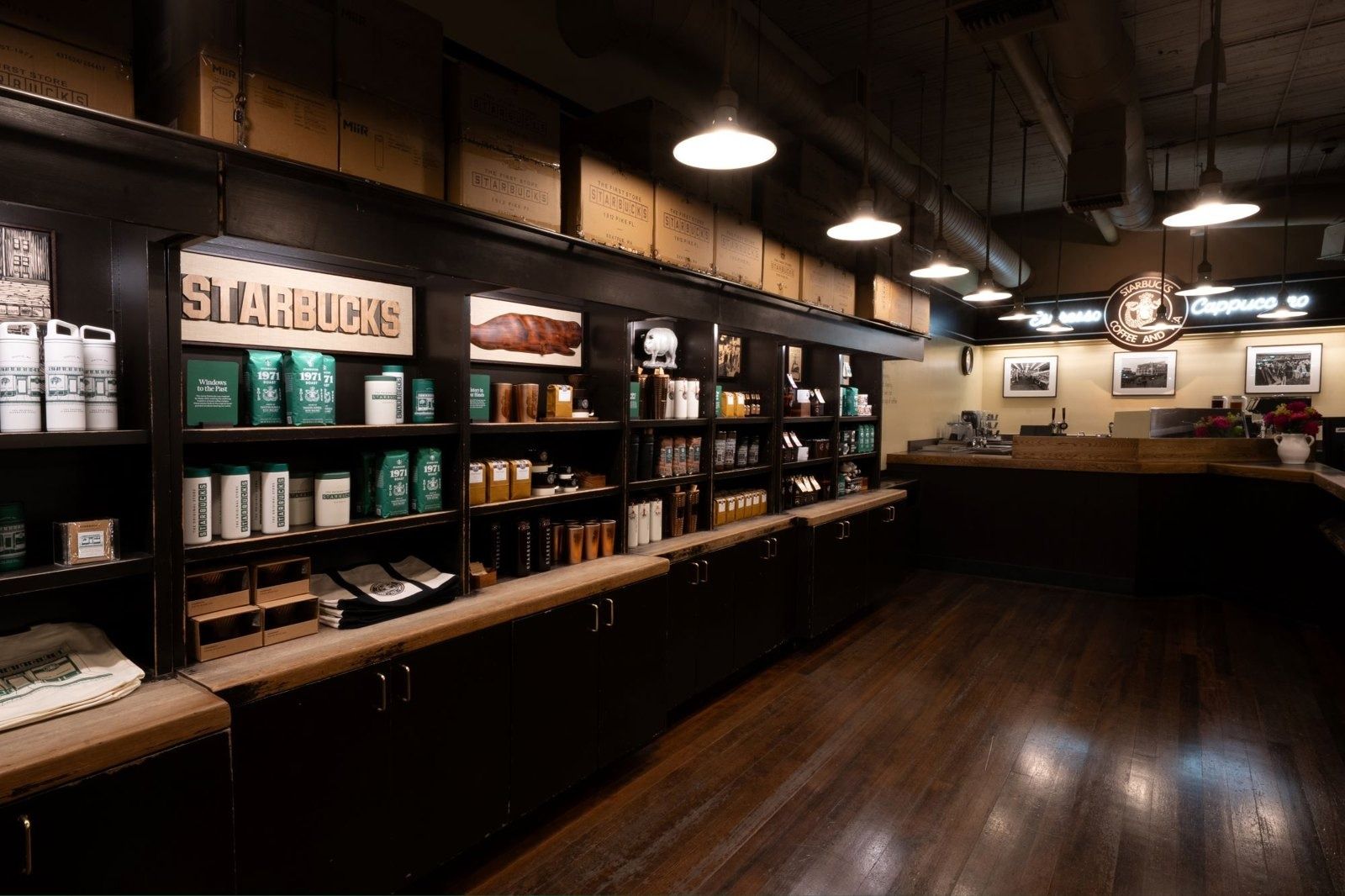Starbucks: Wood floors and shelves of coffee in the Pike Place store