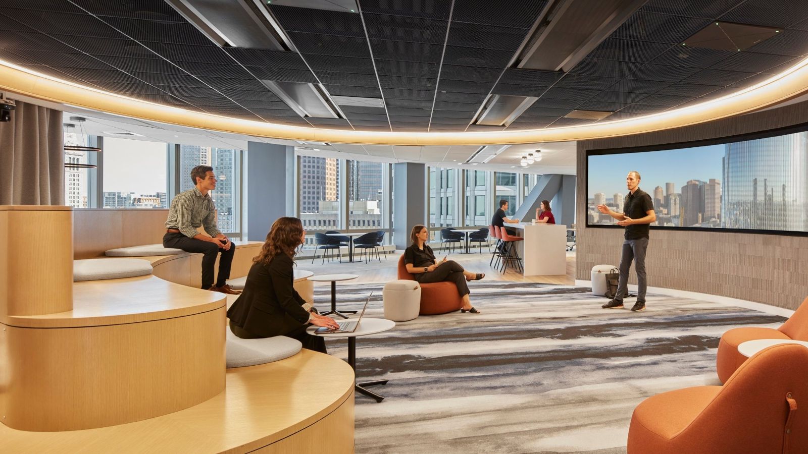 State Street: Lounge with curved wooden benches and orange chairs