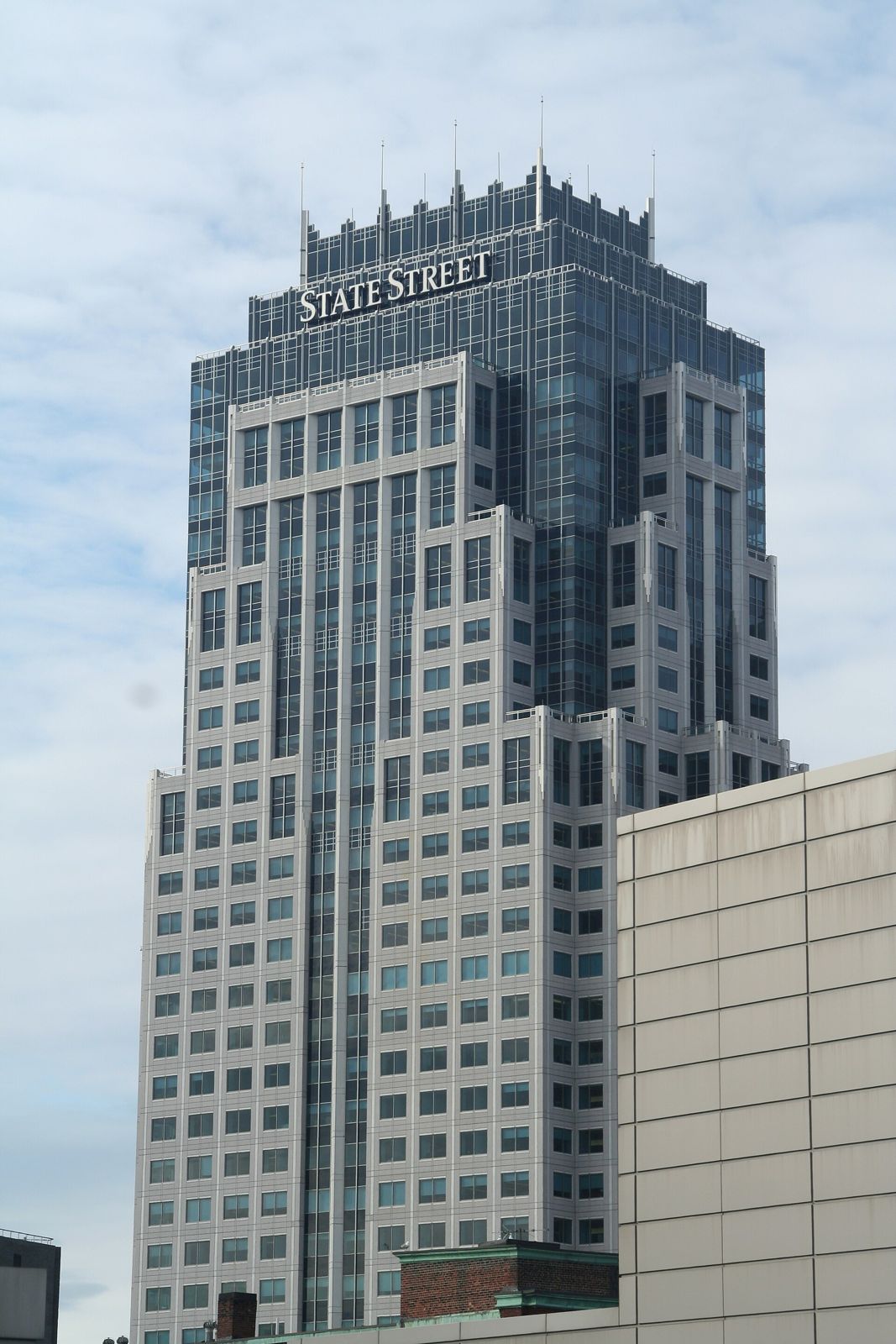 Tall tower with a stepped top seen from a rooftop