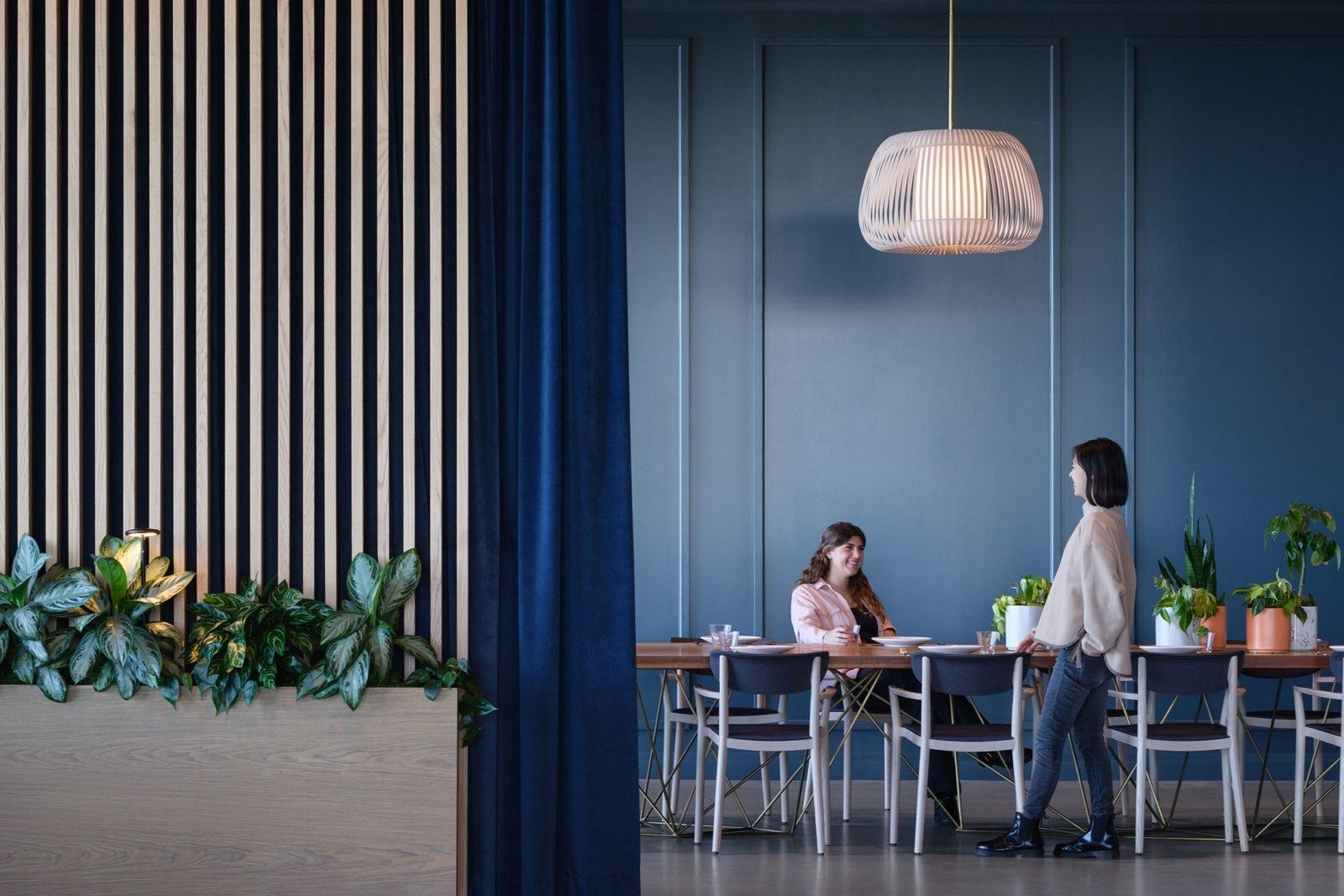 Stripe: A blue meeting area with a pendant lamp