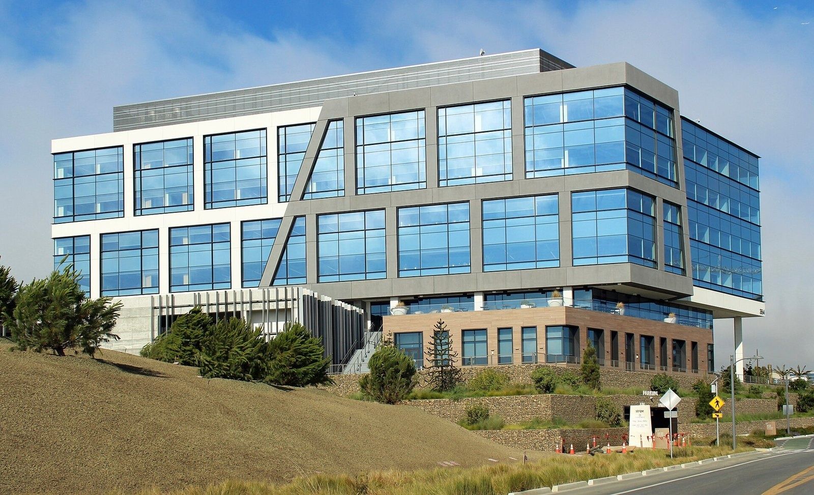 Stripe: Stripe's glass headquarters on a hillside at Oyster Point