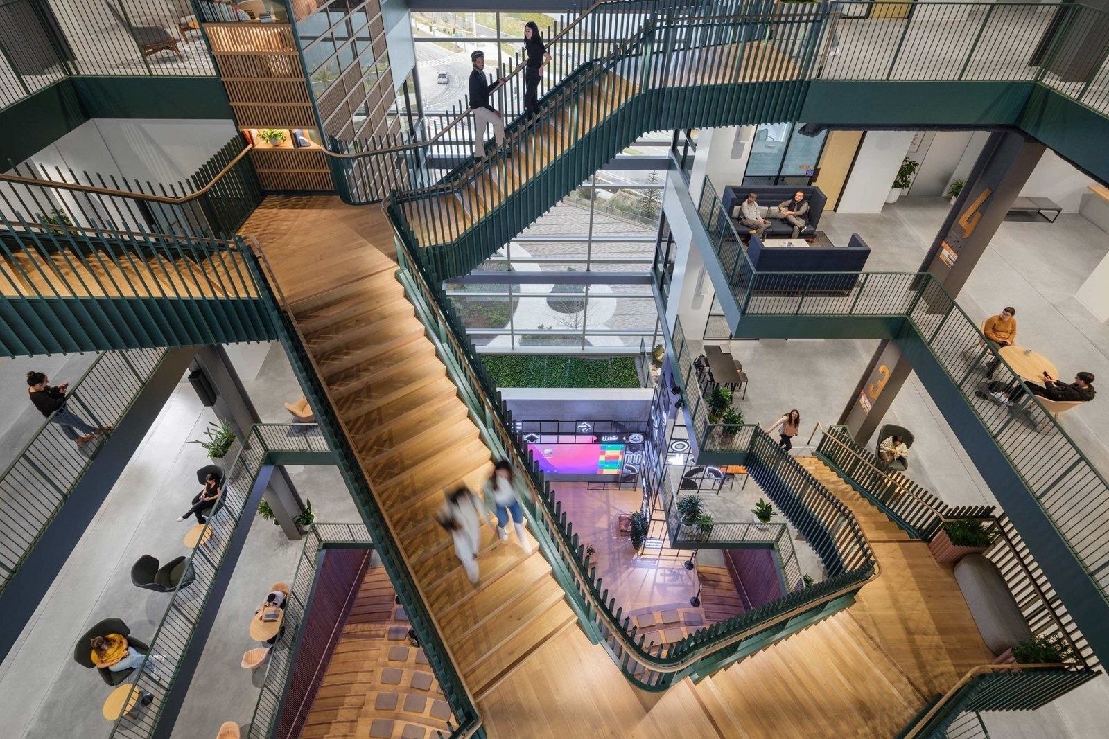 Timber stairs criss-crossing a five-storey atrium