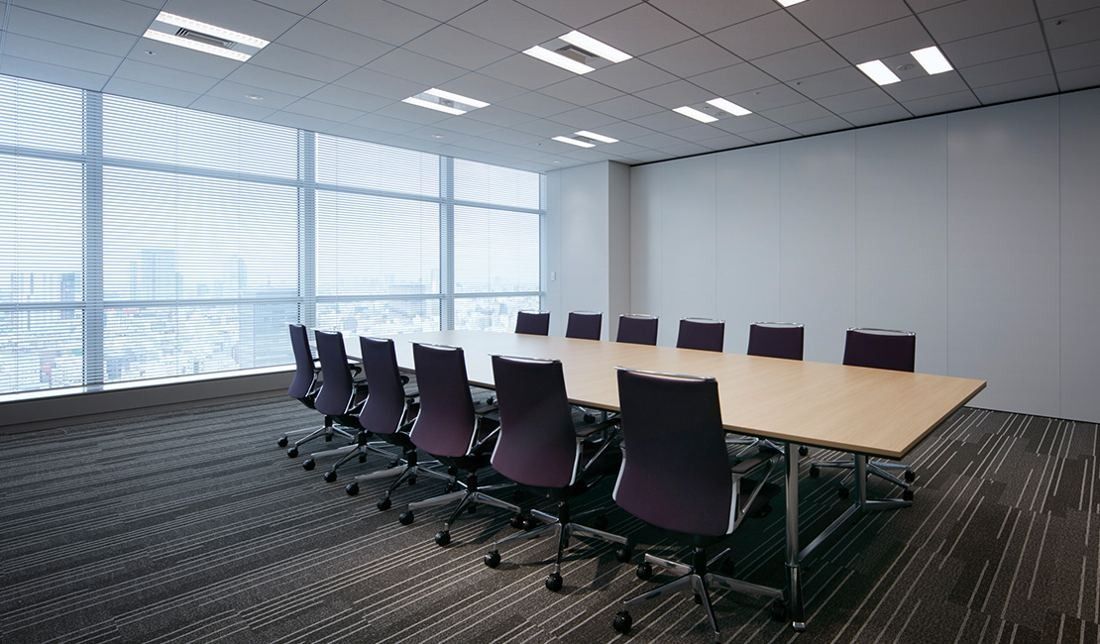 Sumitomo Corporation: Bright meeting room with a long table and dark chairs