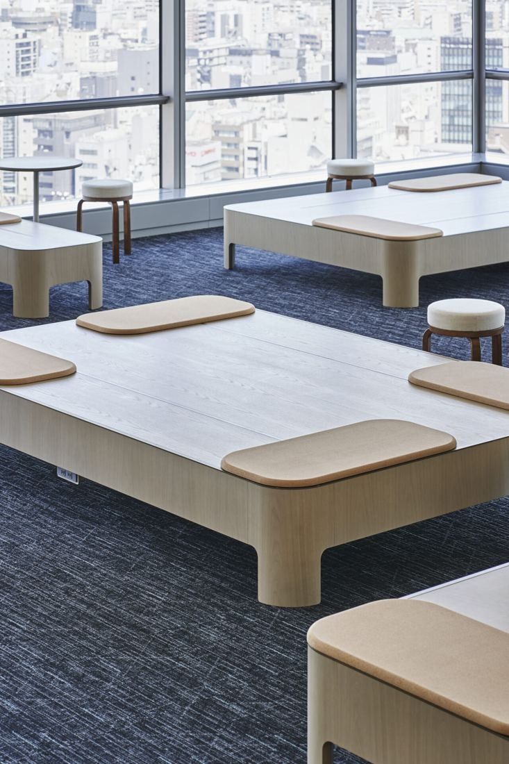 Sumitomo Corporation: Low wooden platforms with cushions on blue carpet near windows