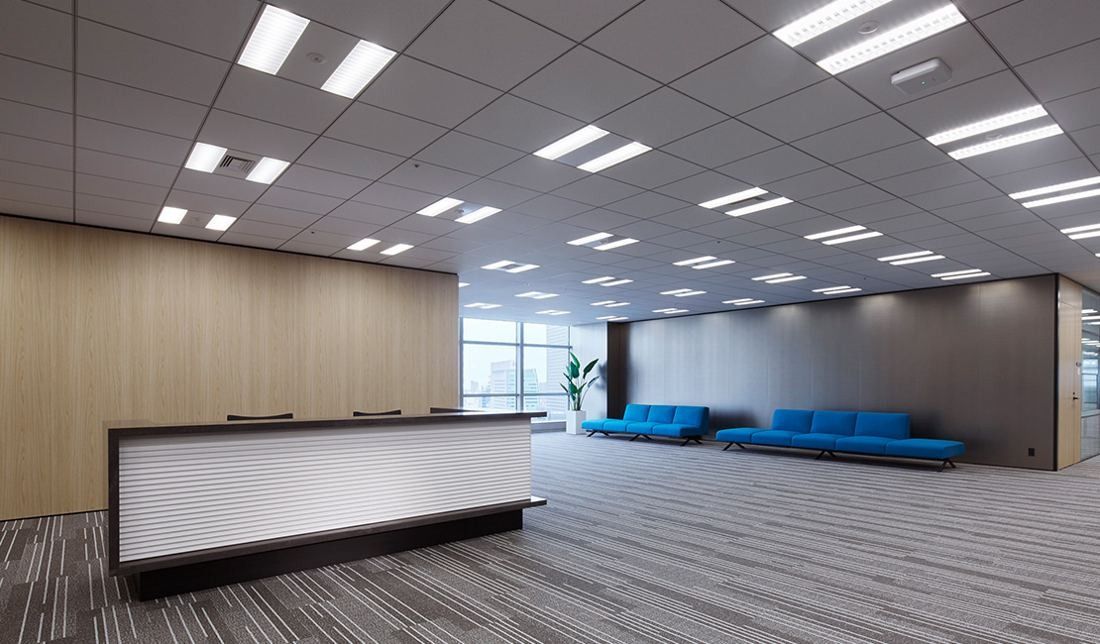 Sumitomo Corporation: Reception desk with blue sofas in a carpeted waiting area