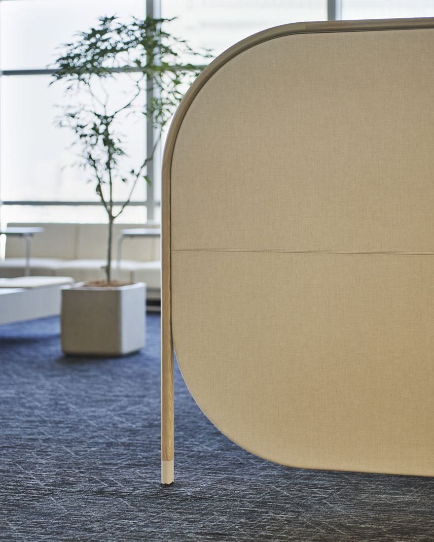 Sumitomo Corporation: Rounded wooden partition and a potted tree near the windows