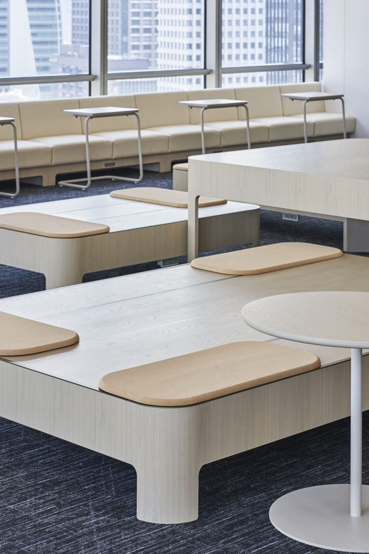 Sumitomo Corporation: Rows of wooden bench platforms with cushions and a high counter by the windows