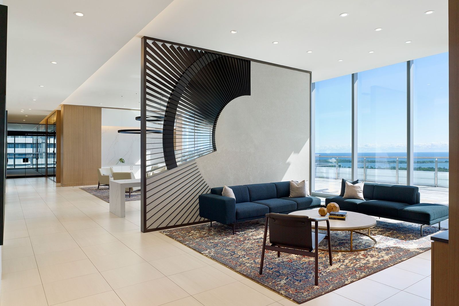 Sun Life: A blue sofa behind a patterned screen with lake views