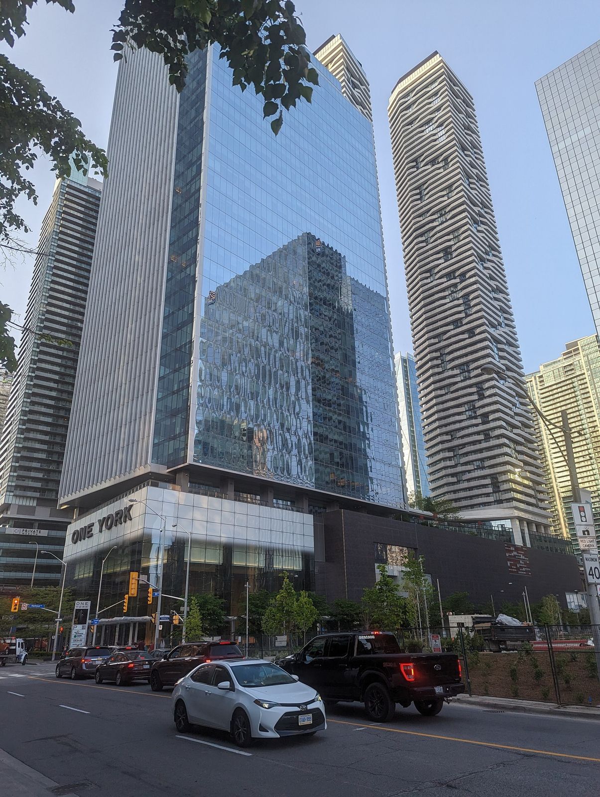 Sun Life: A glass tower and its podium with cars passing
