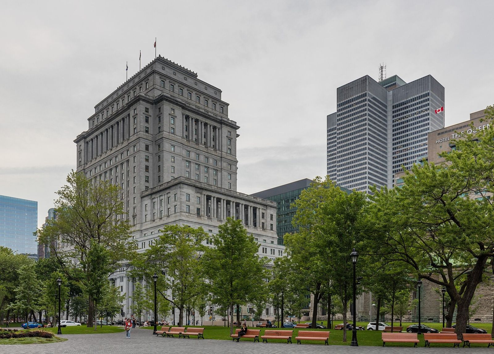 Sun Life: A large stone office building beyond a park with trees