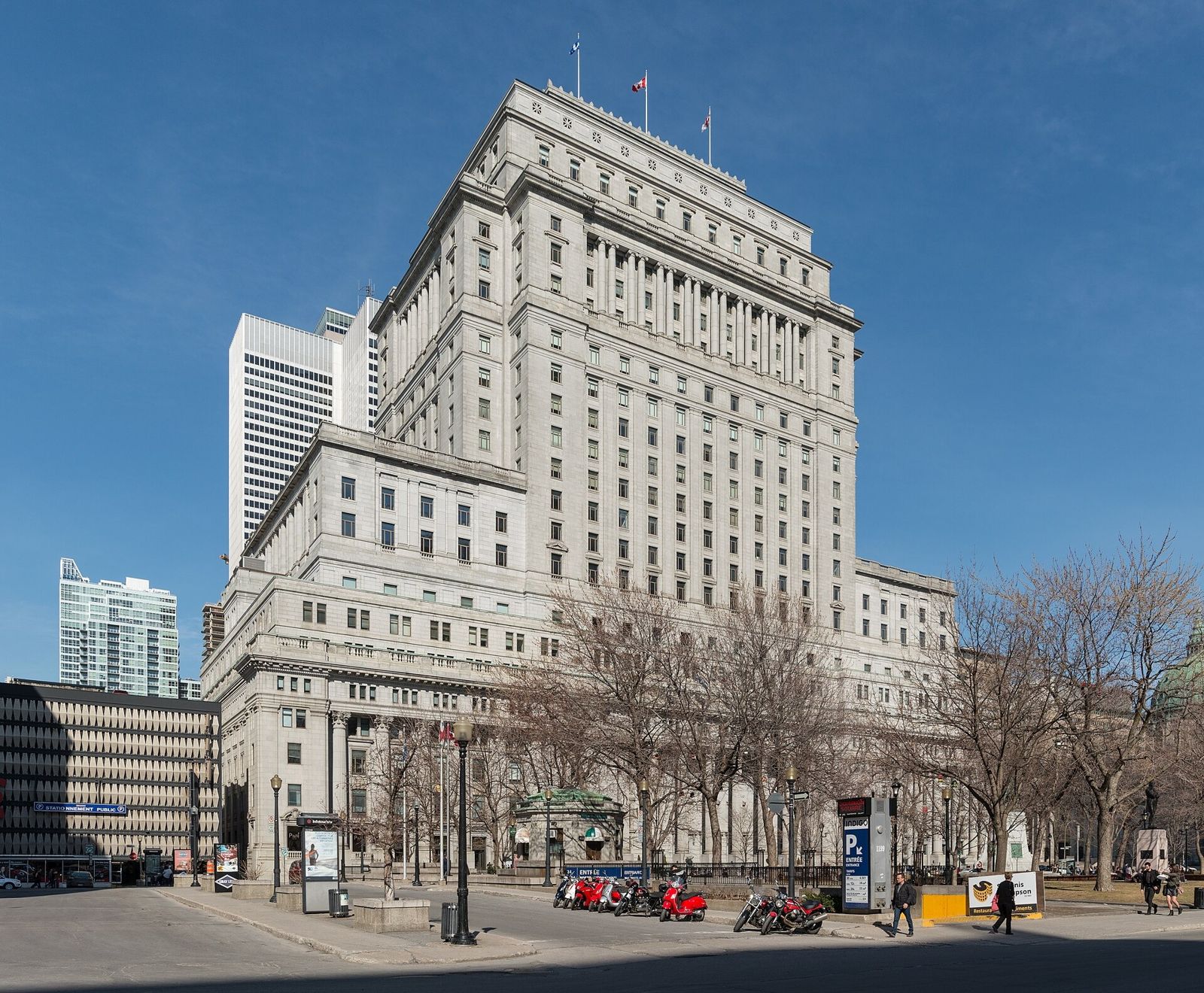 A massive stone office building with columns on a sunny day
