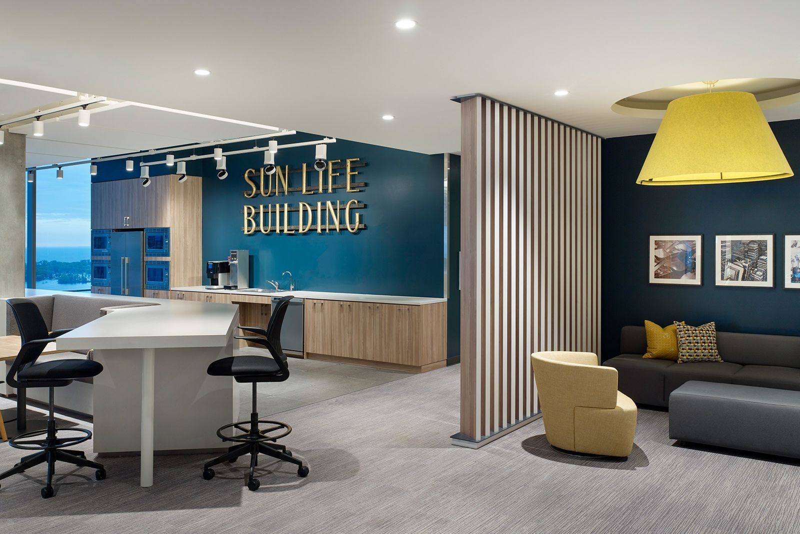 Sun Life: A teaming area with a Sun Life Building sign and yellow chairs