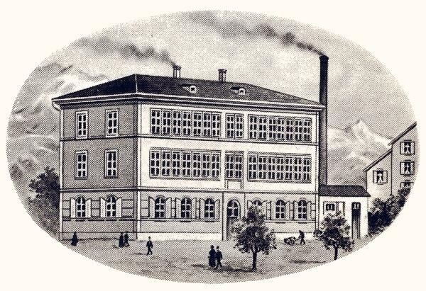 Engraving of a multi-storey factory building with a tall chimney in an oval frame