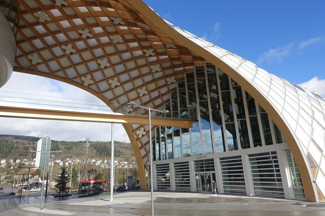 The Swatch Group: Underside of the timber grid arch rising over a glazed entrance façade