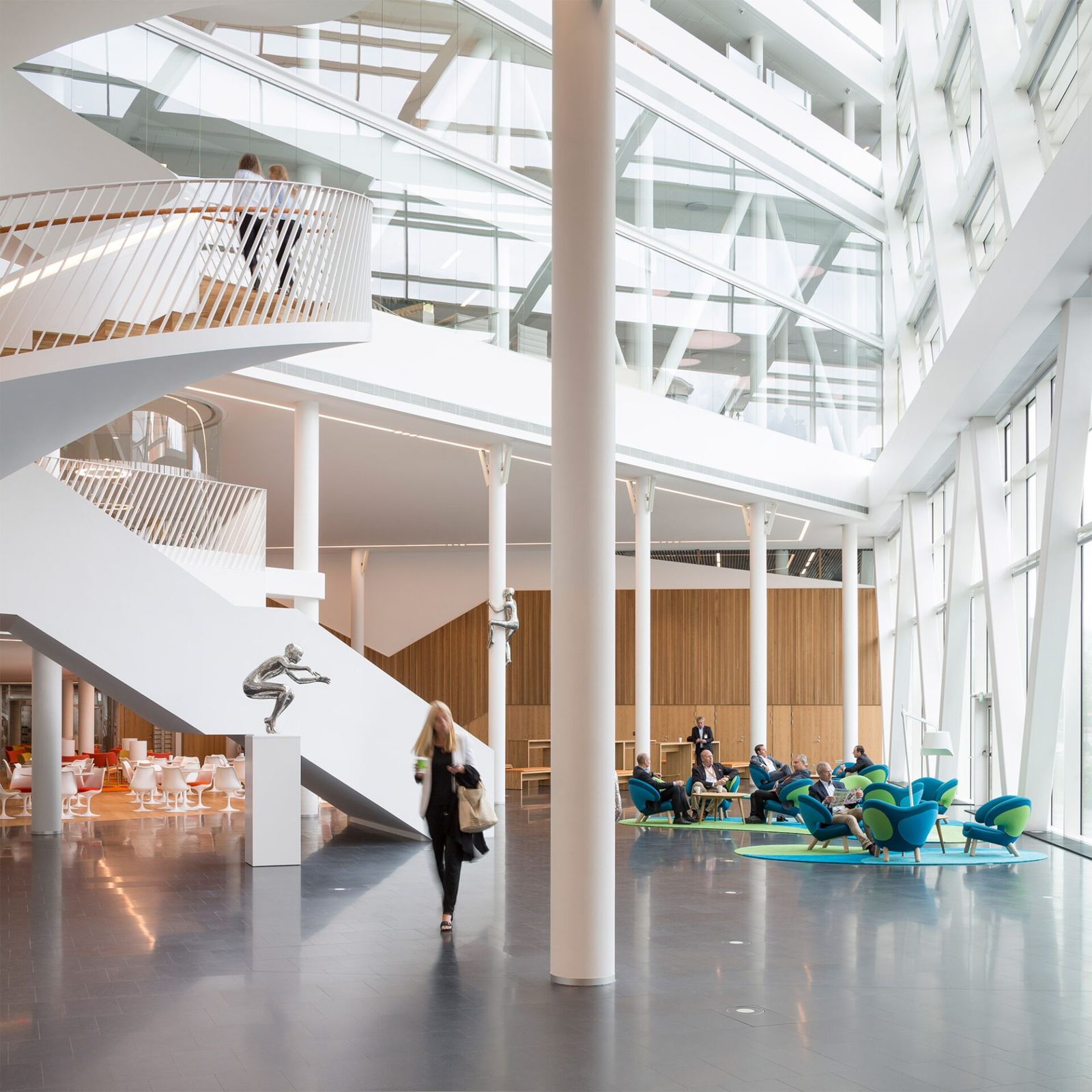 Swedbank: Ground floor of an atrium with a white stair and colorful seats