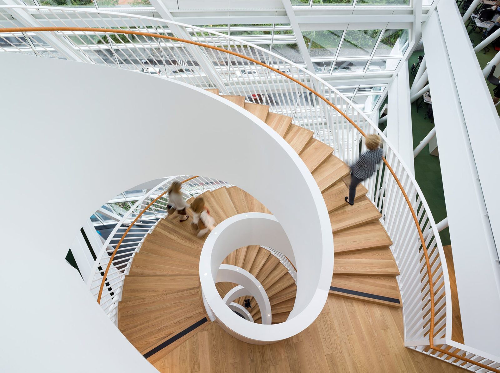 Swedbank: Looking down a white spiral stair with wooden steps